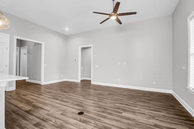 unfurnished room with dark wood-type flooring and ceiling fan