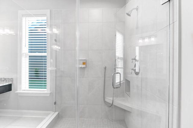 bathroom featuring a shower with door and tile patterned floors