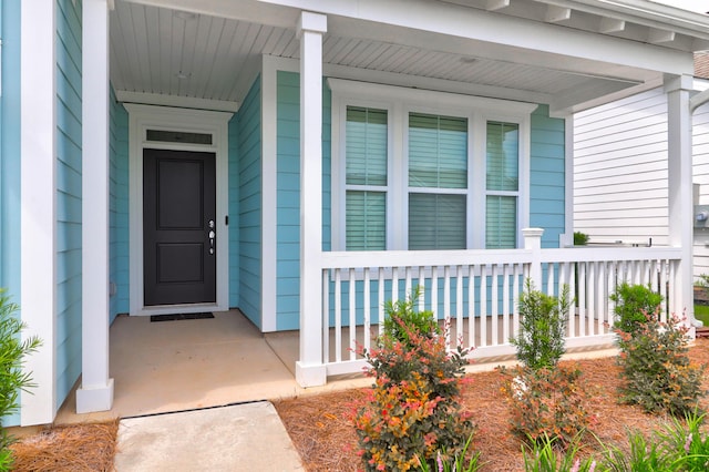 view of exterior entry with a porch