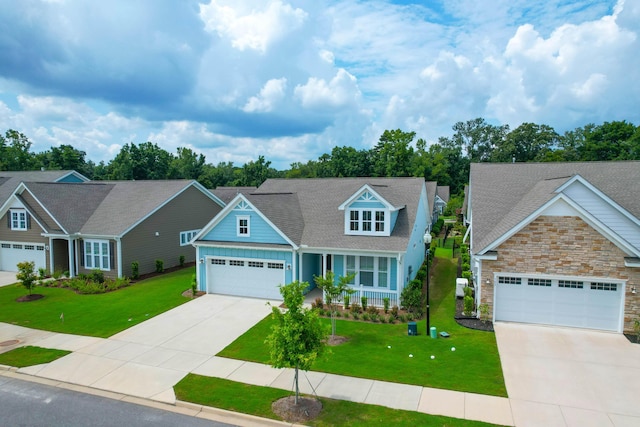 craftsman-style home with a porch, a garage, and a front yard