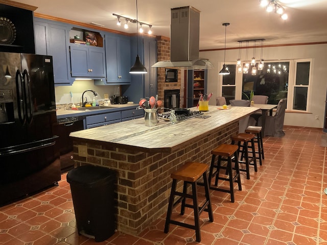 306 Park St, Saint George, SC 29477 - kitchen featuring black appliances, wall chimney exhaust hood, ornamental molding, a breakfast bar, and a center island