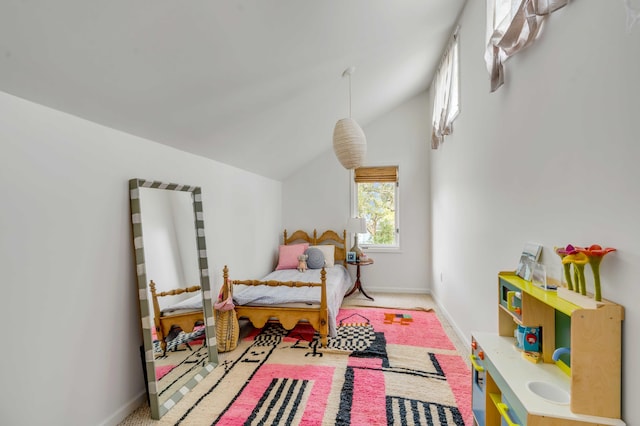 bedroom with carpet, baseboards, and vaulted ceiling