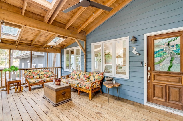 sunroom / solarium featuring wood ceiling, vaulted ceiling with skylight, and ceiling fan