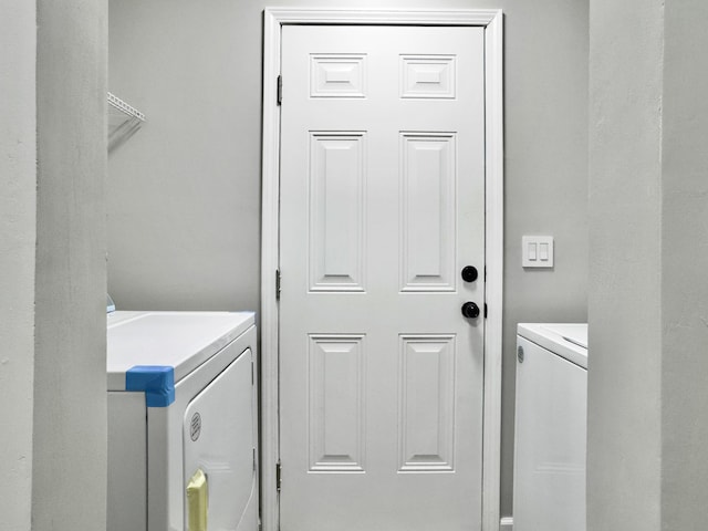 clothes washing area featuring washer and clothes dryer