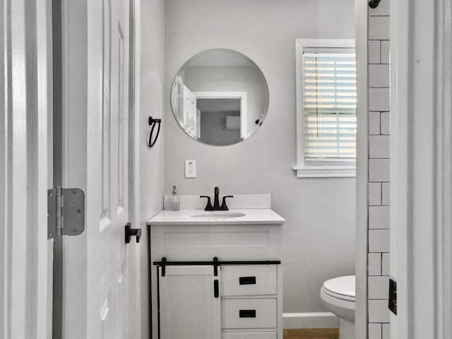 bathroom featuring vanity and toilet