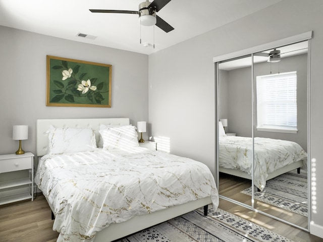 bedroom featuring ceiling fan, wood-type flooring, and a closet