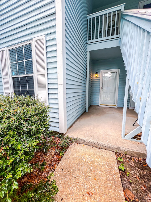 view of exterior entry featuring a patio