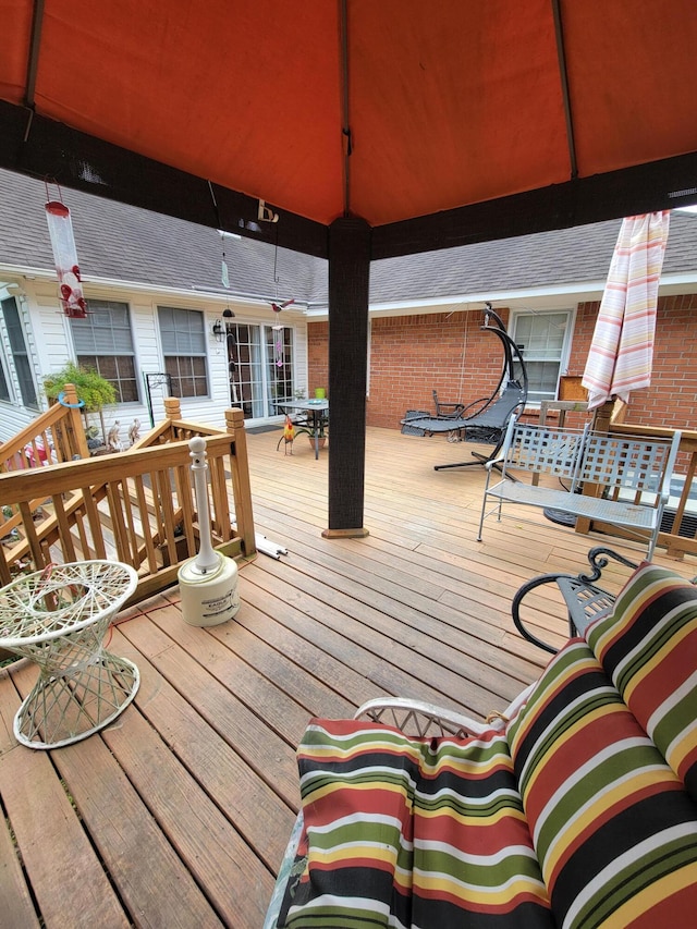 wooden deck featuring outdoor lounge area and a gazebo