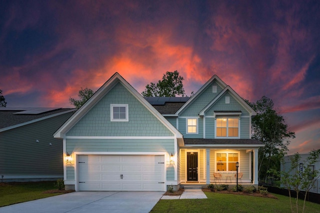 770 Opal Wing St, Moncks Corner, SC 29461 - craftsman house with a porch, concrete driveway, roof mounted solar panels, a lawn, and an attached garage