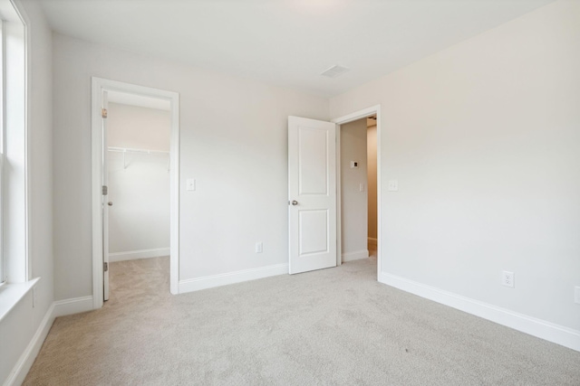770 Opal Wing St, Moncks Corner, SC 29461 - unfurnished bedroom featuring light colored carpet, a walk in closet, a closet, and baseboards