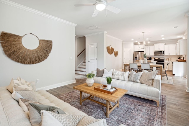770 Opal Wing St, Moncks Corner, SC 29461 - living room featuring crown molding, light wood-style floors, a ceiling fan, stairway, and baseboards