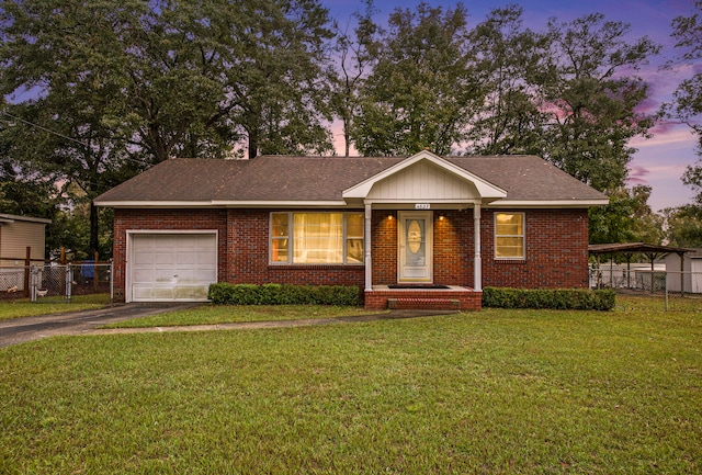 single story home with a yard and a garage