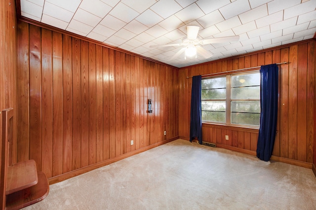 carpeted spare room with ceiling fan