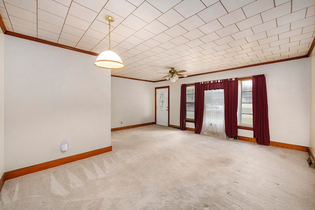 carpeted empty room with crown molding and ceiling fan