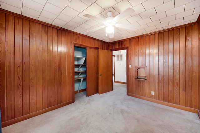 unfurnished bedroom with light colored carpet and ceiling fan