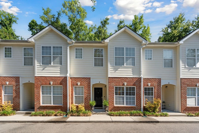 view of property featuring brick siding