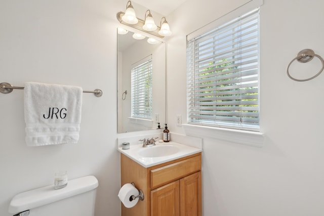 half bath featuring toilet and vanity