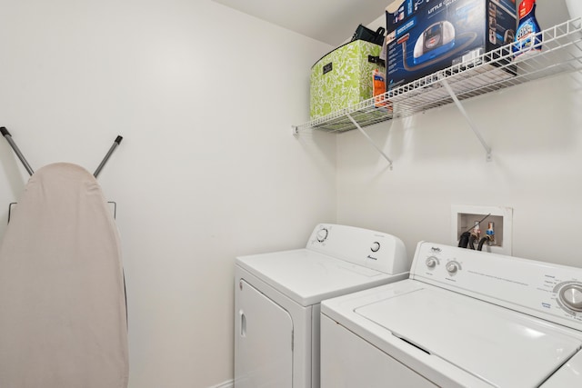 laundry room featuring separate washer and dryer and laundry area