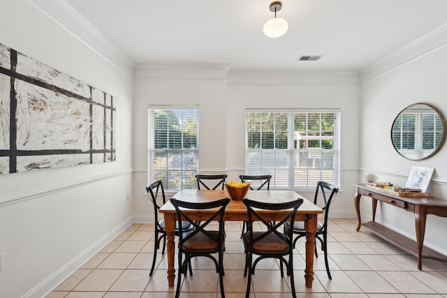 dining space with light tile patterned floors, ornamental molding, and visible vents