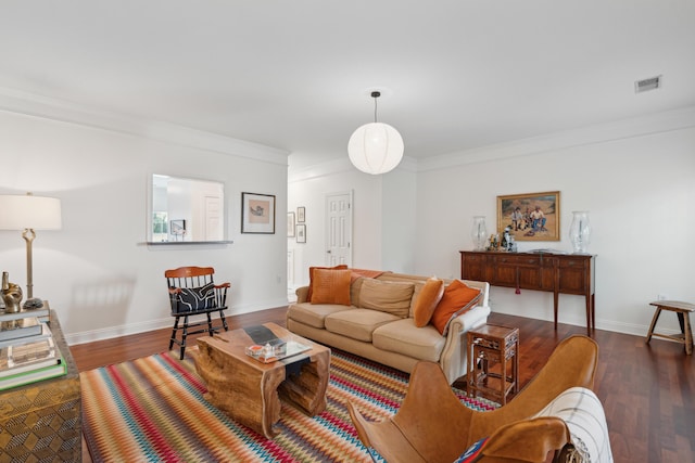 living room featuring crown molding, baseboards, visible vents, and wood finished floors