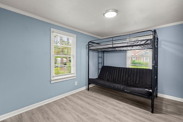 407 Raysor St, Saint George, SC 29477 - unfurnished bedroom with ornamental molding, wood finished floors, baseboards, and multiple windows
