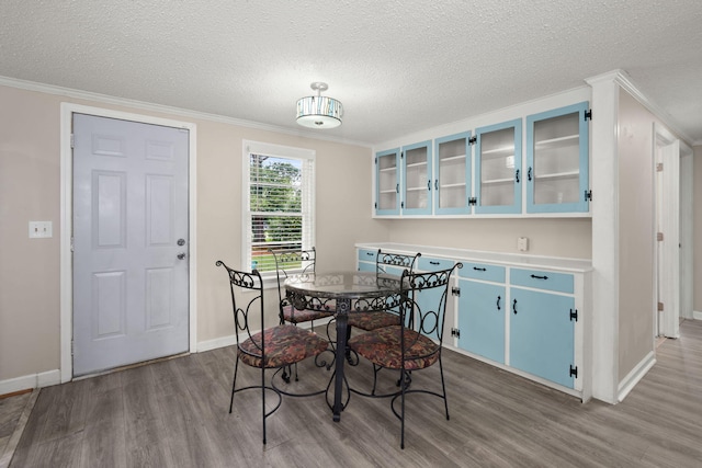 407 Raysor St, Saint George, SC 29477 - dining space with wood finished floors, ornamental molding, baseboards, and a textured ceiling