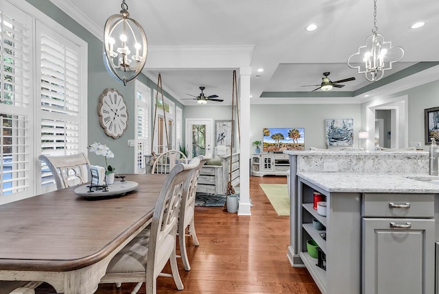 1033 Tuckers Rd, Pawleys Island, SC 29585 - dining space featuring ornamental molding, ceiling fan with notable chandelier, wood finished floors, and a wealth of natural light