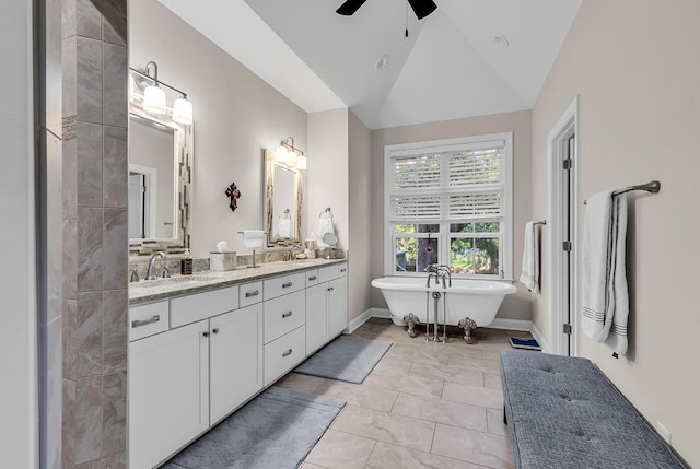 1033 Tuckers Rd, Pawleys Island, SC 29585 - bathroom with double vanity, ceiling fan, a freestanding tub, a sink, and lofted ceiling