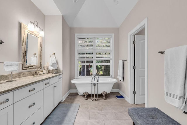 1033 Tuckers Rd, Pawleys Island, SC 29585 - bathroom featuring vaulted ceiling, a freestanding tub, baseboards, and vanity