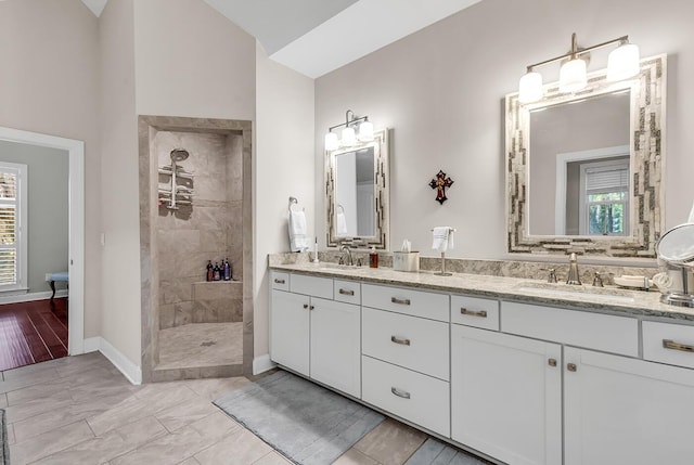 1033 Tuckers Rd, Pawleys Island, SC 29585 - full bathroom with a walk in shower, baseboards, a healthy amount of sunlight, and a sink