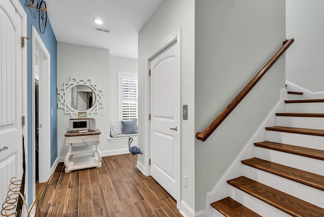 1033 Tuckers Rd, Pawleys Island, SC 29585 - foyer entrance with dark wood finished floors, baseboards, stairs, and visible vents
