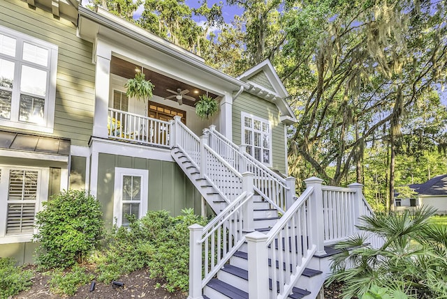 1033 Tuckers Rd, Pawleys Island, SC 29585 - view of exterior entry with a porch, a ceiling fan, and board and batten siding