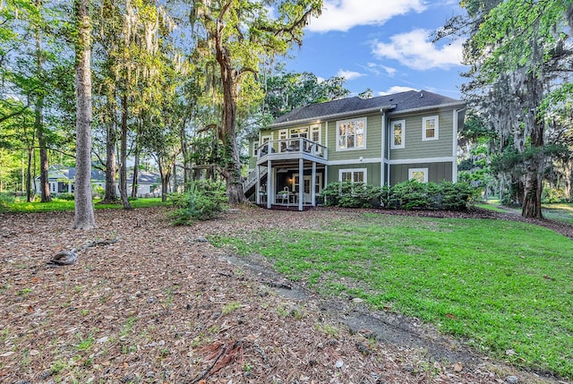 1033 Tuckers Rd, Pawleys Island, SC 29585 - rear view of house featuring a wooden deck, a yard, and stairway