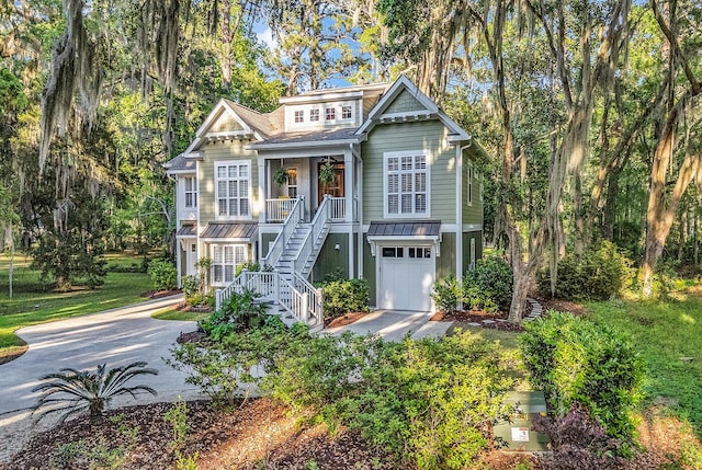 1033 Tuckers Rd, Pawleys Island, SC 29585 - view of front of home featuring covered porch, driveway, stairs, and a garage