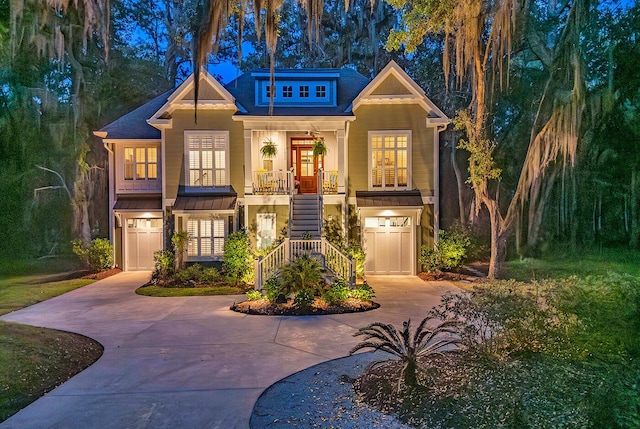 1033 Tuckers Rd, Pawleys Island, SC 29585 - view of front facade with a garage, covered porch, stairway, and concrete driveway