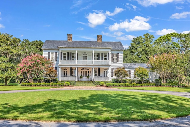 1033 Tuckers Rd, Pawleys Island, SC 29585 - greek revival inspired property featuring covered porch, a chimney, and a front yard