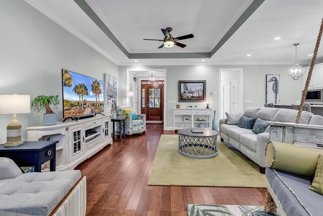 1033 Tuckers Rd, Pawleys Island, SC 29585 - living room with crown molding, ceiling fan with notable chandelier, a tray ceiling, recessed lighting, and dark wood-type flooring