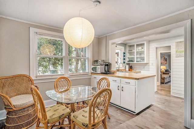 504 W Ashley Ave, Folly Beach, SC 29439 - dining area with ornamental molding and light wood-style floors