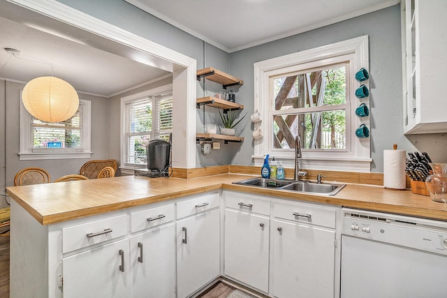 504 W Ashley Ave, Folly Beach, SC 29439 - kitchen featuring dishwasher, ornamental molding, a peninsula, open shelves, and white cabinetry