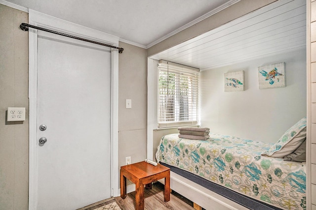 504 W Ashley Ave, Folly Beach, SC 29439 - bedroom featuring wood finished floors and crown molding