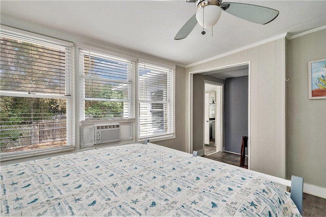 504 W Ashley Ave, Folly Beach, SC 29439 - bedroom with multiple windows, ornamental molding, cooling unit, wood finished floors, and a ceiling fan