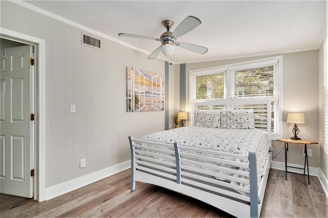504 W Ashley Ave, Folly Beach, SC 29439 - bedroom with ornamental molding, wood finished floors, and ceiling fan