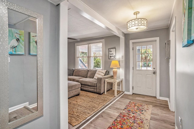 504 W Ashley Ave, Folly Beach, SC 29439 - entrance foyer featuring plenty of natural light, light wood-type flooring, and beamed ceiling