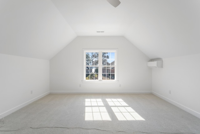 bonus room featuring light carpet, baseboards, vaulted ceiling, and an AC wall unit