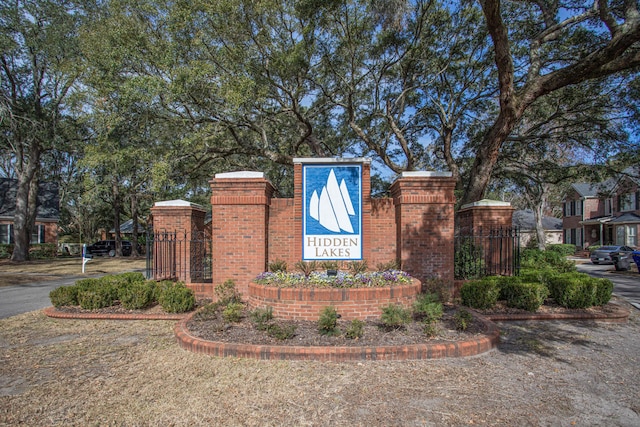 community sign featuring a gate