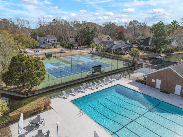 community pool featuring fence and a patio