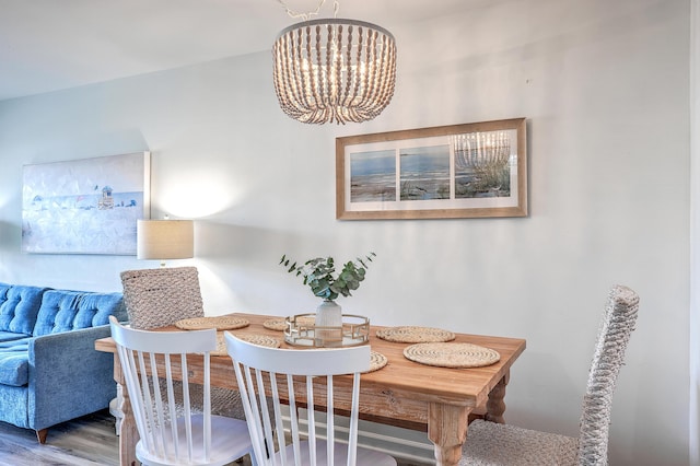 dining room featuring wood-type flooring and a notable chandelier