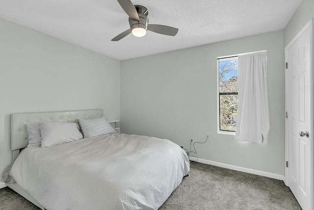 carpeted bedroom with a ceiling fan and baseboards