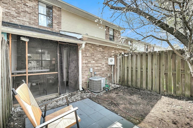 exterior space with fence and central AC