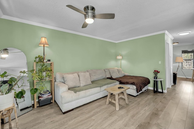 living area with light wood finished floors, ornamental molding, and arched walkways